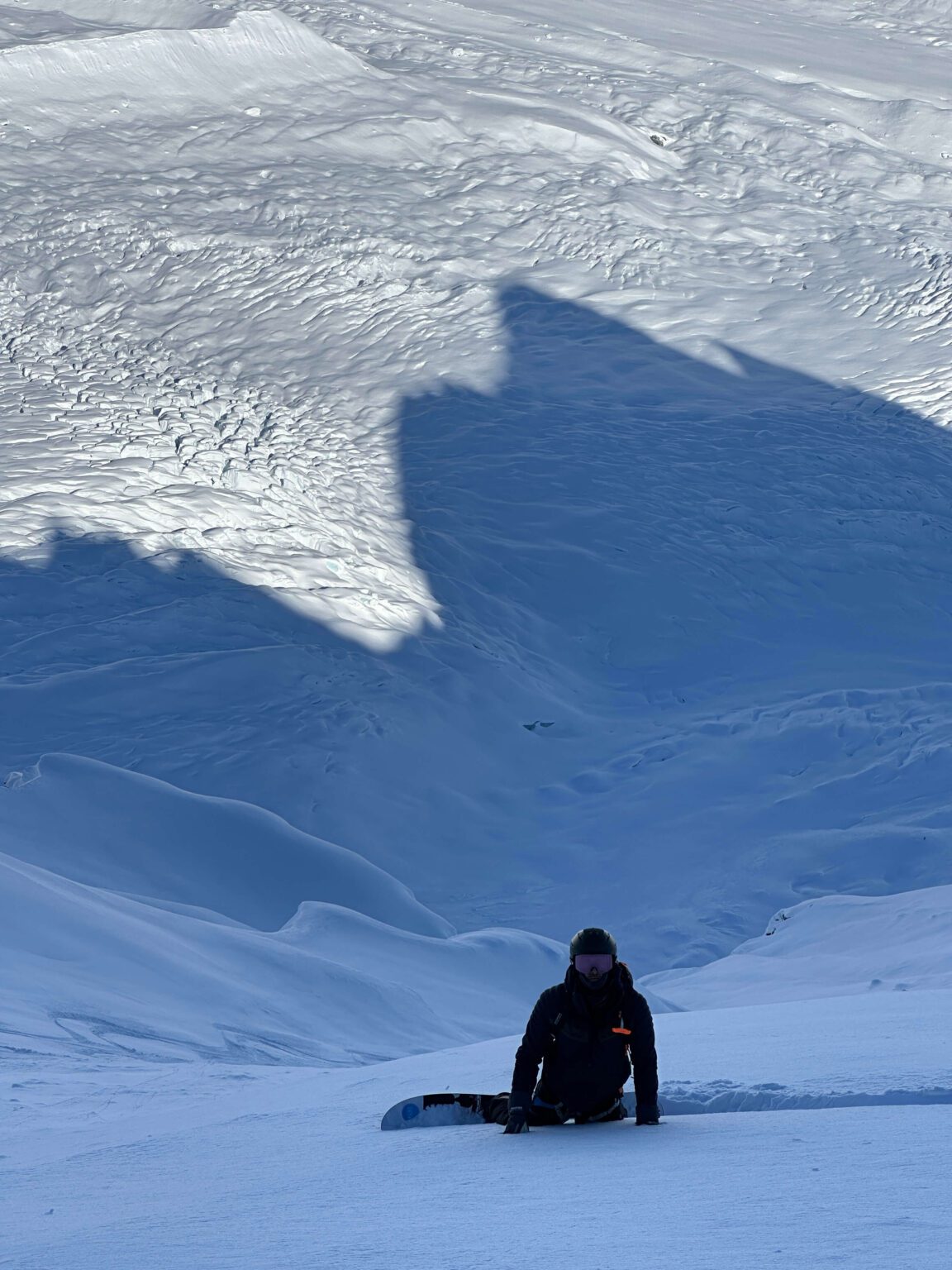 Snowboarder above a glacier in the Chugach